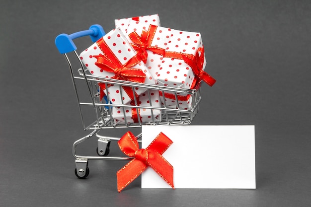 Cart full of gifts with place for text mock up. Black Friday and holidays concept.