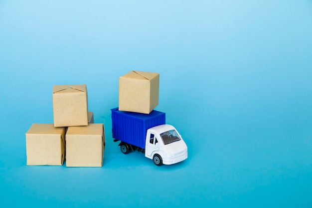 Carton boxes and blue truck on blue background Cargo transportation delivery service