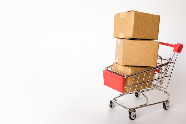 Cartons or Paper boxes in red shopping cart on white background. with copy space