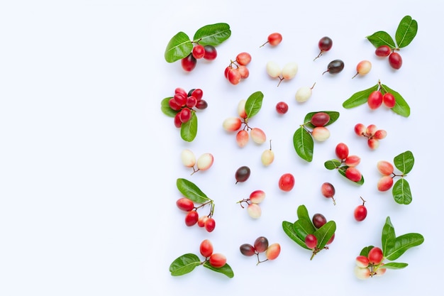 Carunda or Karonda fruits with leaves isolated on white 