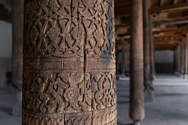 Carved wooden column in Juma masjid ancient mosque in old city of IchanKala Khiva Uzbekistan