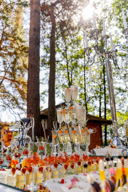 Cascade of champagne glasses. Pyramid of glasses for champagne or drinks. Vacation at the party. Catering table with snacks.