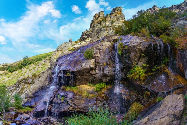 Cascade of fresh water falling between the rocks of the high mountains. Somosierra Madrid.