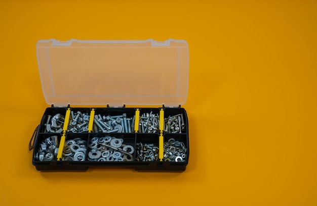 https://img.freepik.com/premium-photo/case-organizer-with-screws-nuts-washers-yellow-background-located-right_664825-405.jpg