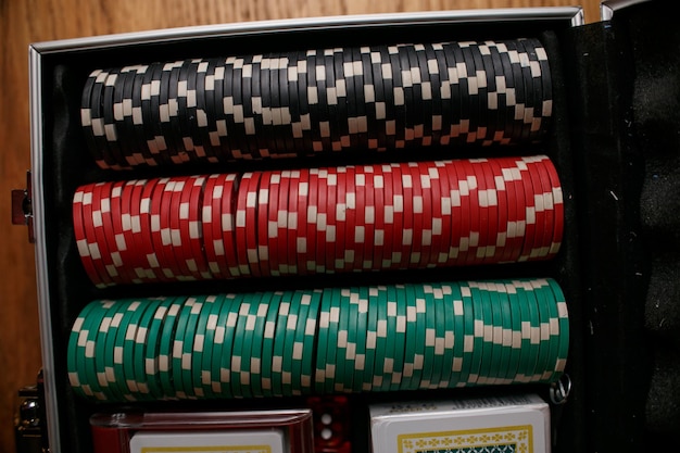 Case with chips in casino opened suitcase with gaming chips\
betting in poker gambling addiction