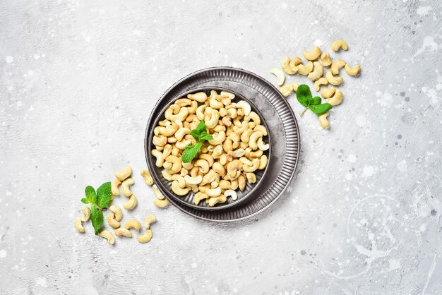 Cashew nut on a stone background. Roasted nuts. Assortment of nuts. Top view.