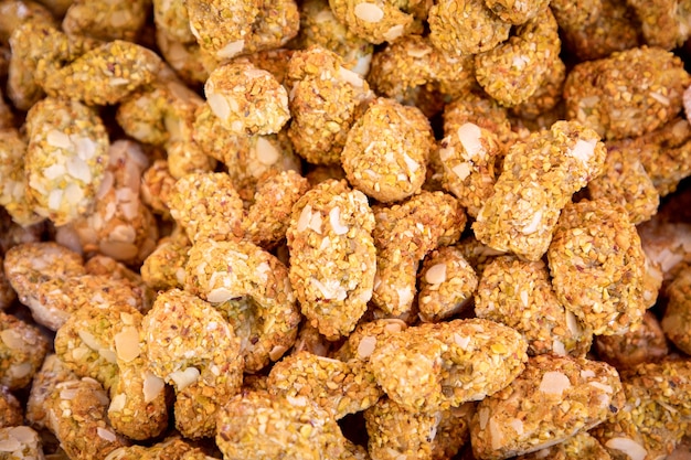 Cashew nuts covered with icing and pistachio crumbs