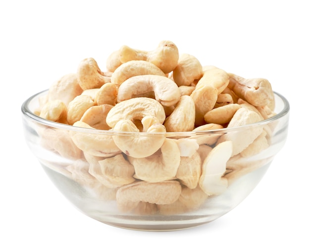 Cashew nuts in a glass plate close-up on a white. Isolated