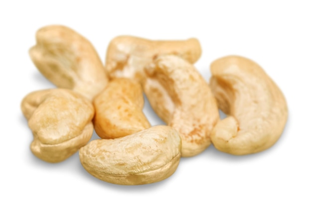 Cashew nuts heap on white background