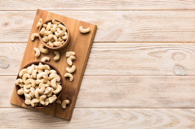 cashew nuts in wooden bowl on table background top view Space for text Healthy food