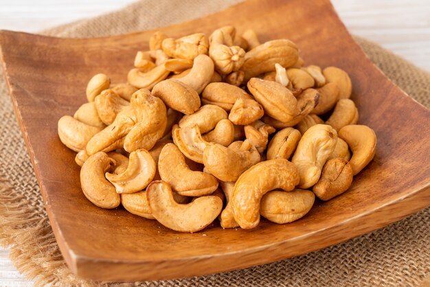 Cashew nuts in wooden bowl with copy space