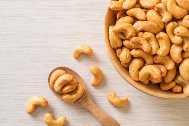 Cashew nuts in wooden bowl with copy space