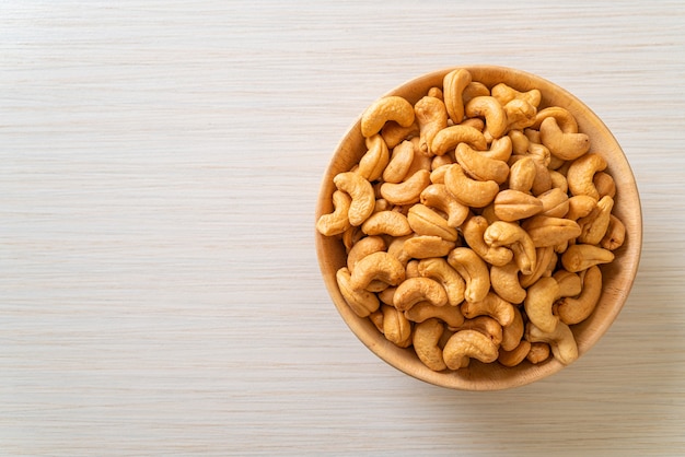 Cashew nuts in wooden bowl with copy space