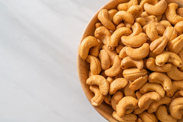 Cashew nuts in wooden bowl with copy space