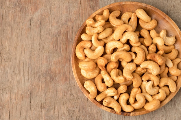 Cashew nuts in wooden bowl  on woden table.