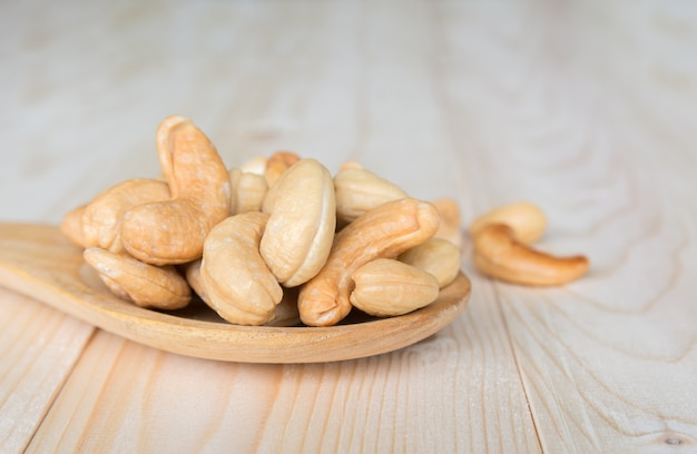 Cashews nuts on wooden spoon