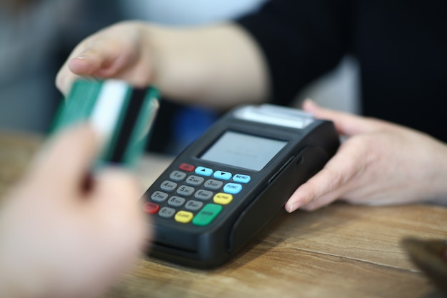 Cashier Hand Taking Plastic Credit Card to Payment