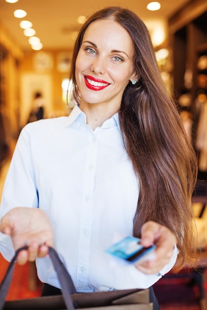 Cashier handing over the purchases and the card