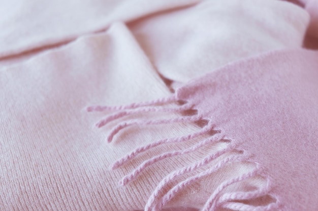 Cashmere texture, natural wool, pink cashmere clothes folded on the table, fabric background