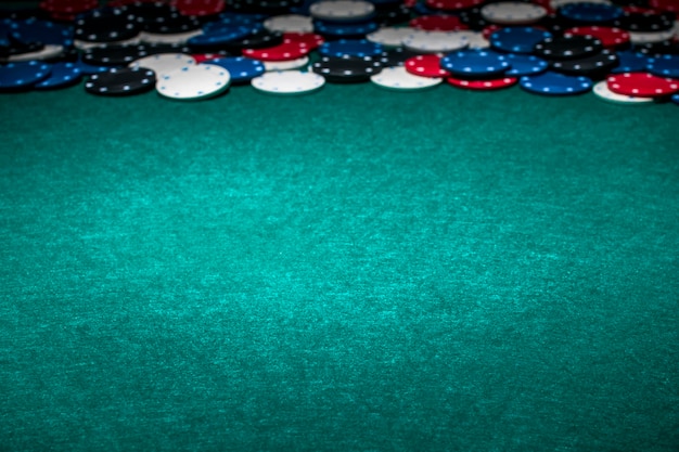 Casino chips on green gambling table