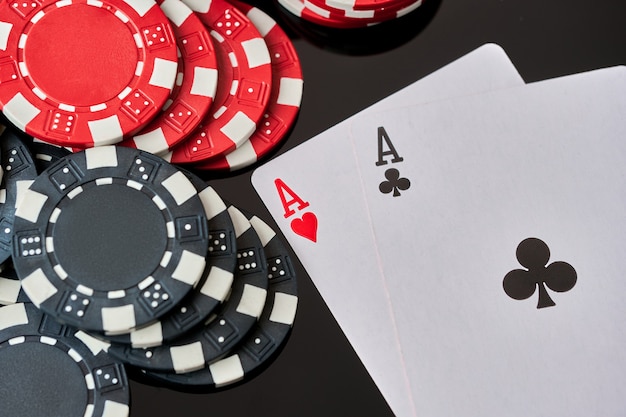 Premium Photo | Casino chips and playing cards on dark reflective background