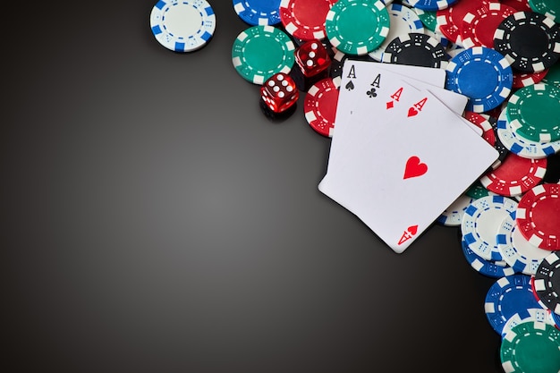 casino chips playing cards and dices on dark reflective background