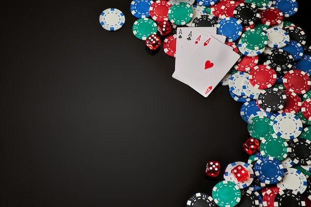 casino chips playing cards and dices on dark reflective background