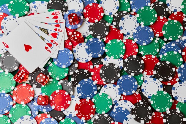 Casino chips playing cards and dices on green fabric table