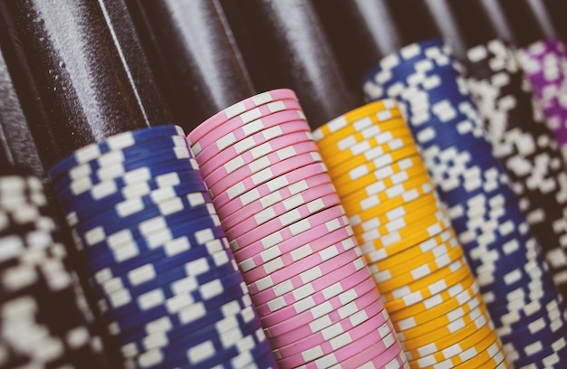 Casino colorful poker chips lie on the game table in the stack\
vintage photo processing