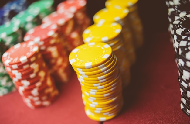 Casino colorful poker chips lie on the game table in the stack\
vintage photo processing