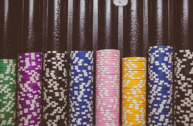 Casino colorful poker chips lie on the game table in the stack\
vintage photo processing