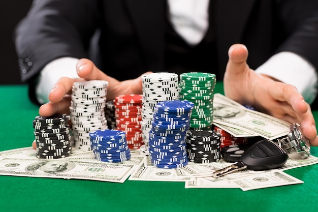 Casino, gambling, people and entertainment concept - close up of poker  player with chips, money and personal stuff at green casino table | Premium  Photo