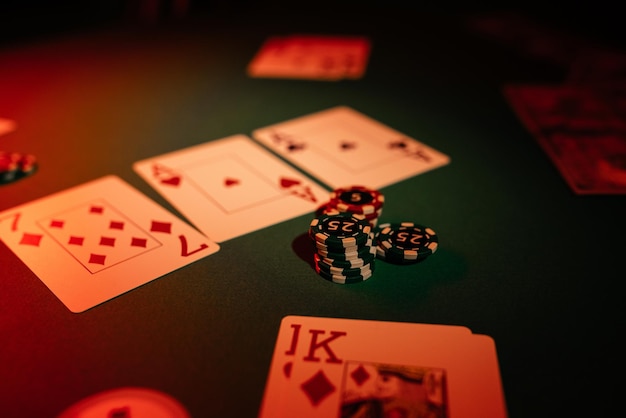 Casino game table closeup dice and playing cards are on a green background