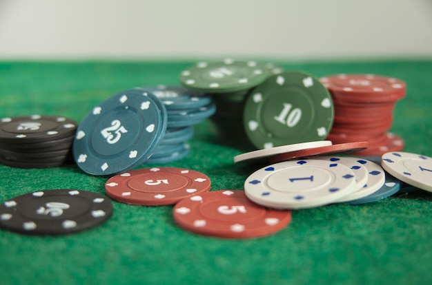 Casino poker chips on green background