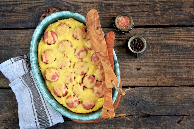 Casserole of mashed potatoes with sausages and cheese