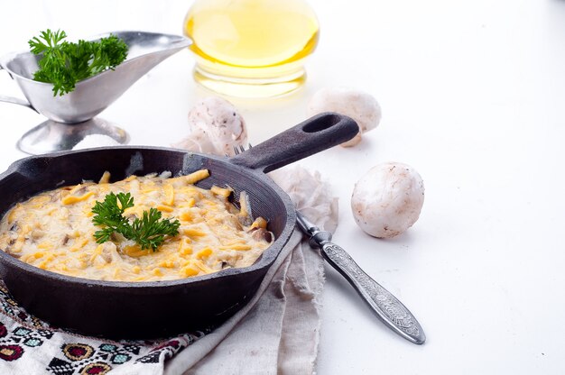 Casserole with chicken and mushrooms on the table. 