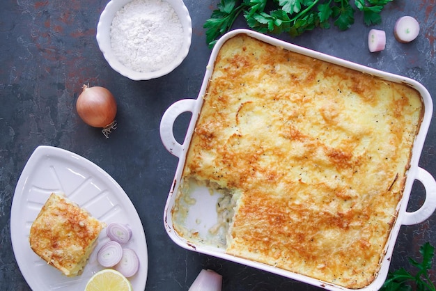 Casserole with fish on dark