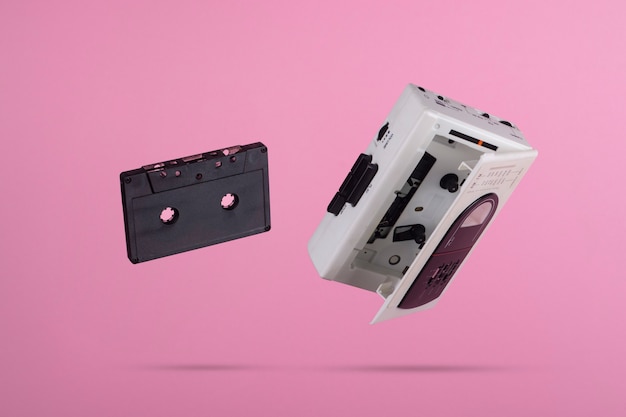 Cassettes floating on a pink background