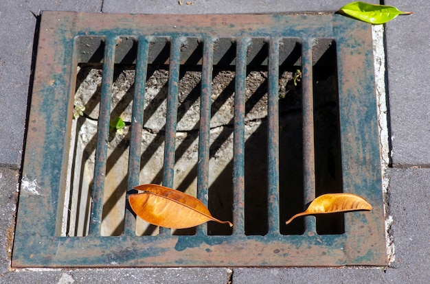 A cast iron drain cover to prevent flooding during the rainy season