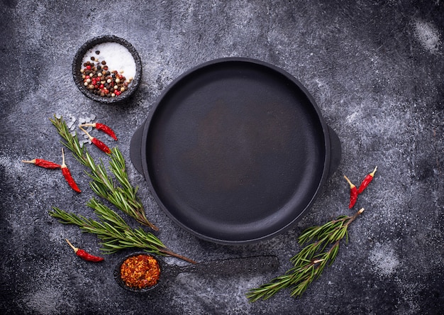 Cast iron frying pan with herbs and spices