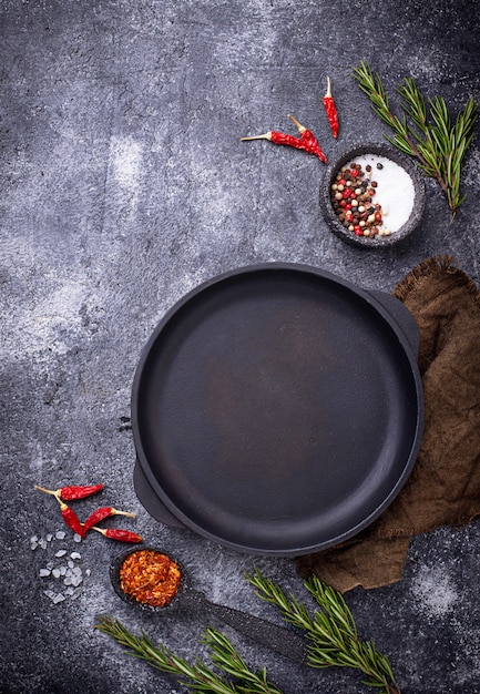 Cast iron frying pan with herbs and spices