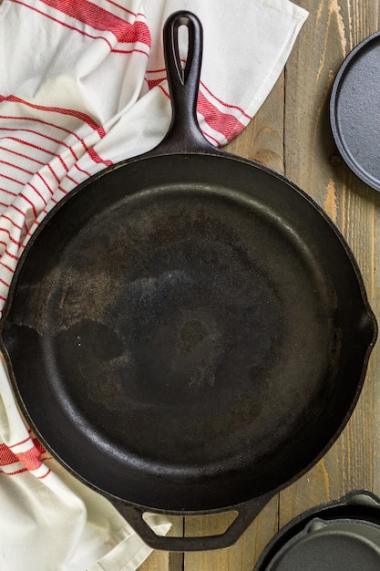 Cast iron skillet on rustic wood table.