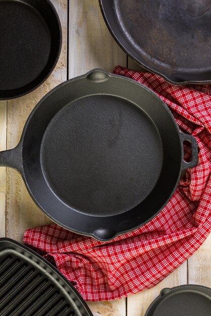 Cast iron skillet on rustic wood table.