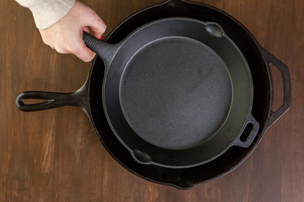 Cast iron skillet on rustic wood table.