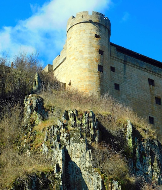 A castle with a large tower on the side of it