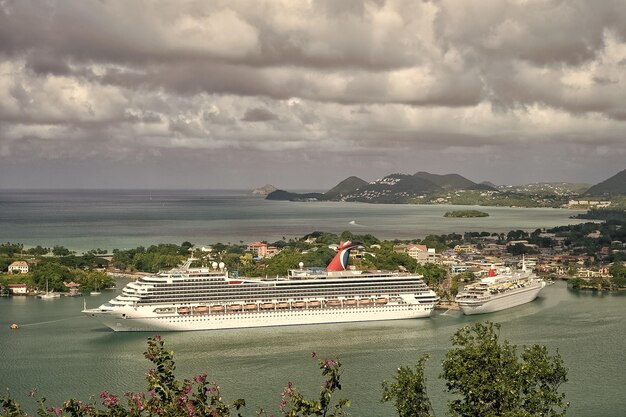 Castries saint lucia november 11 2015 large cruise ship or\
liner carnival liberty tourist boat in bay or harbor picturesque\
landscape luxury trip summer travel and vacation water\
transport