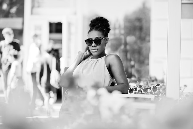 Casual african american girl with colored shopping bags walking outdoor Stylish black woman shopping