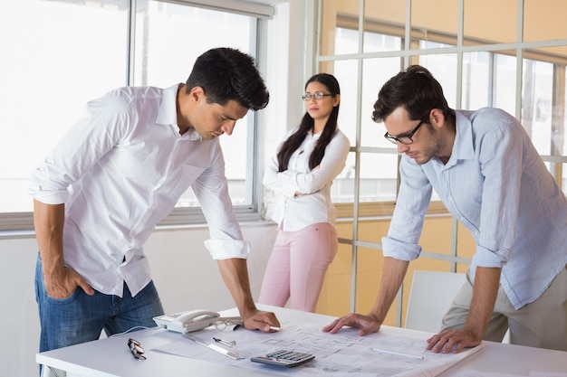 Casual architecture team working together at desk