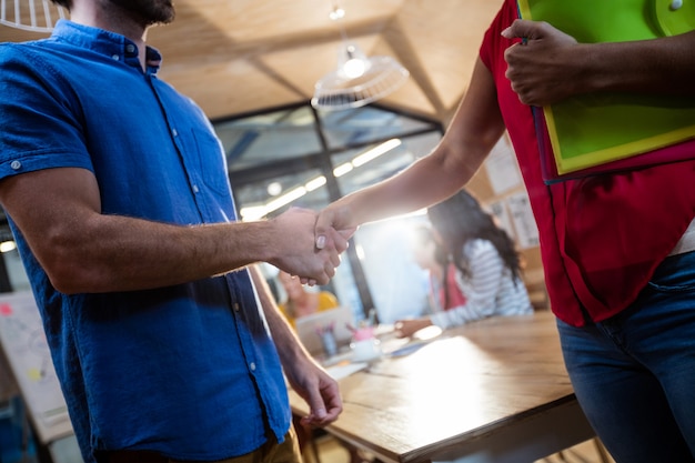 Casual business people shaking their hands