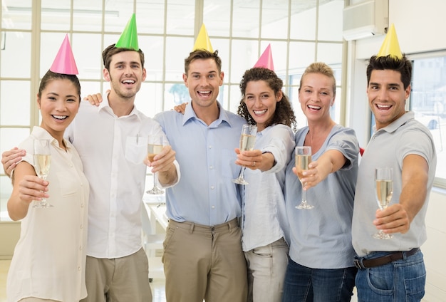 Casual business team celebrating with champagne